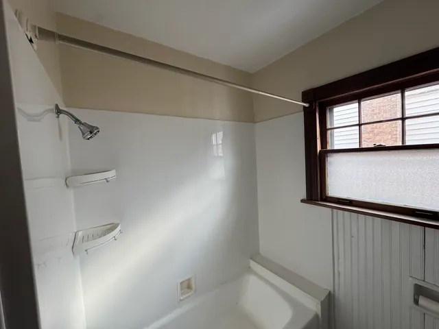 a view of a livingroom with wooden floor and furniture