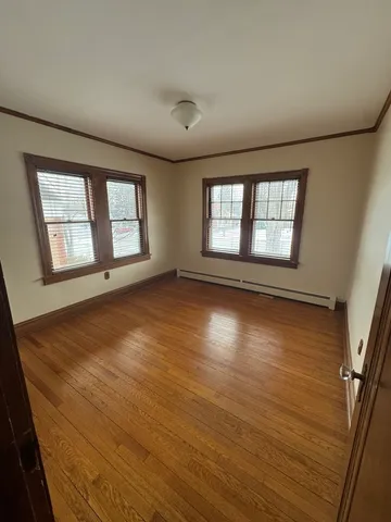 a view of a hallway view with wooden floor and staircase