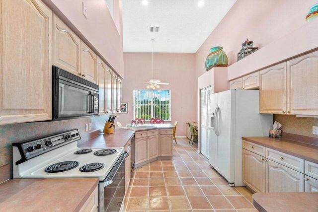 a kitchen with stainless steel appliances a stove a sink refrigerator and a wooden cabinets