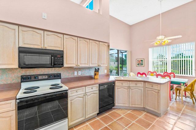 a kitchen with a sink a stove and cabinets