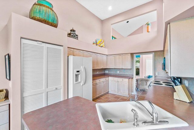 a kitchen with a refrigerator and a sink