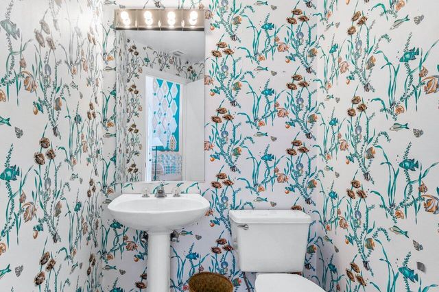a bathroom with a sink and mirror with toilet