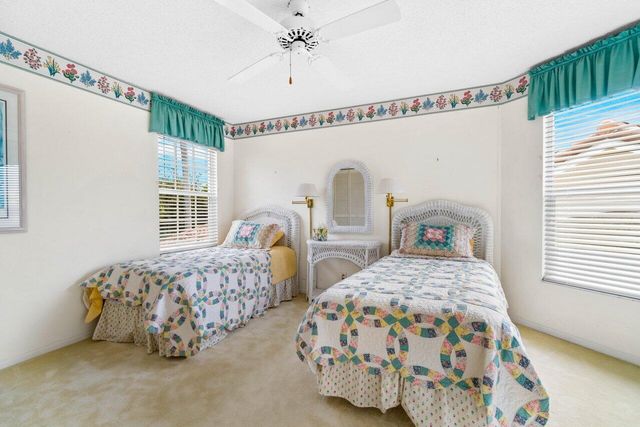 a bedroom with two beds and a window