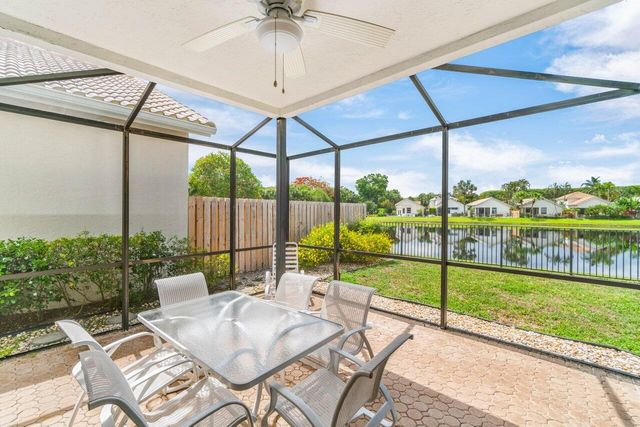 a view of a patio with a table chairs and backyard