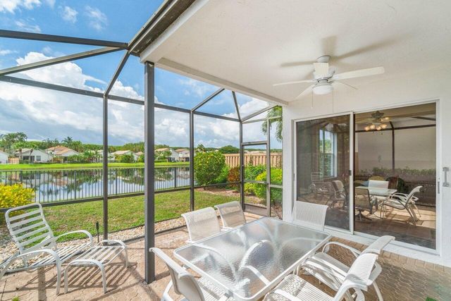 a living room with a floor to ceiling window and a table