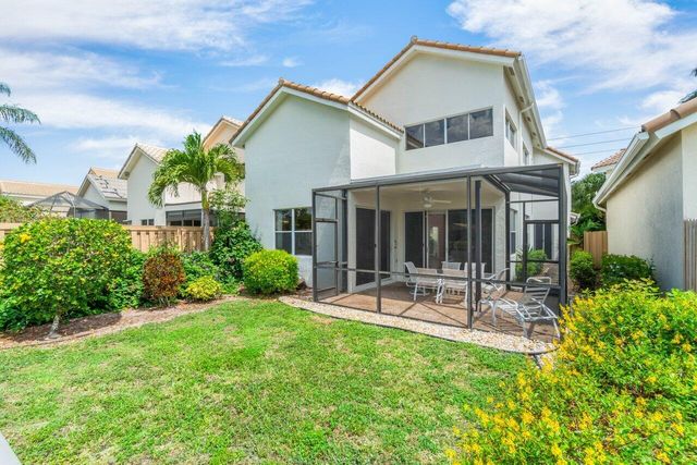 a view of a chair and table in backyard of the house