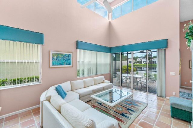 a living room with furniture and a floor to ceiling window