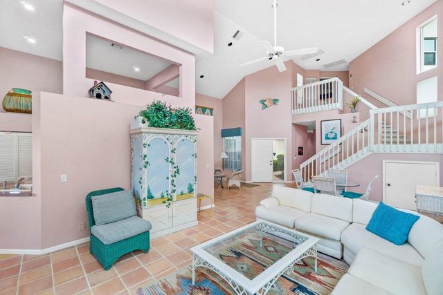 a living room with furniture a chandelier and a rug
