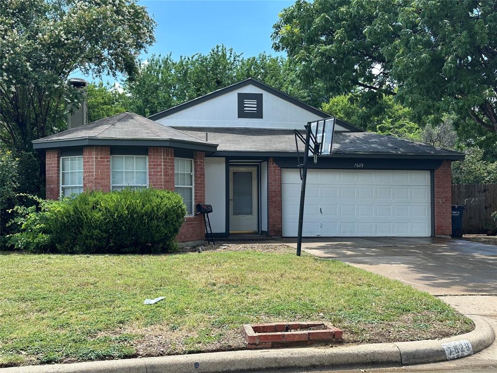 7629 Misty Ridge Drive North Fort Worth, TX 76137 - Photo 1 of 16 a view of a house with a yard plants and large tree