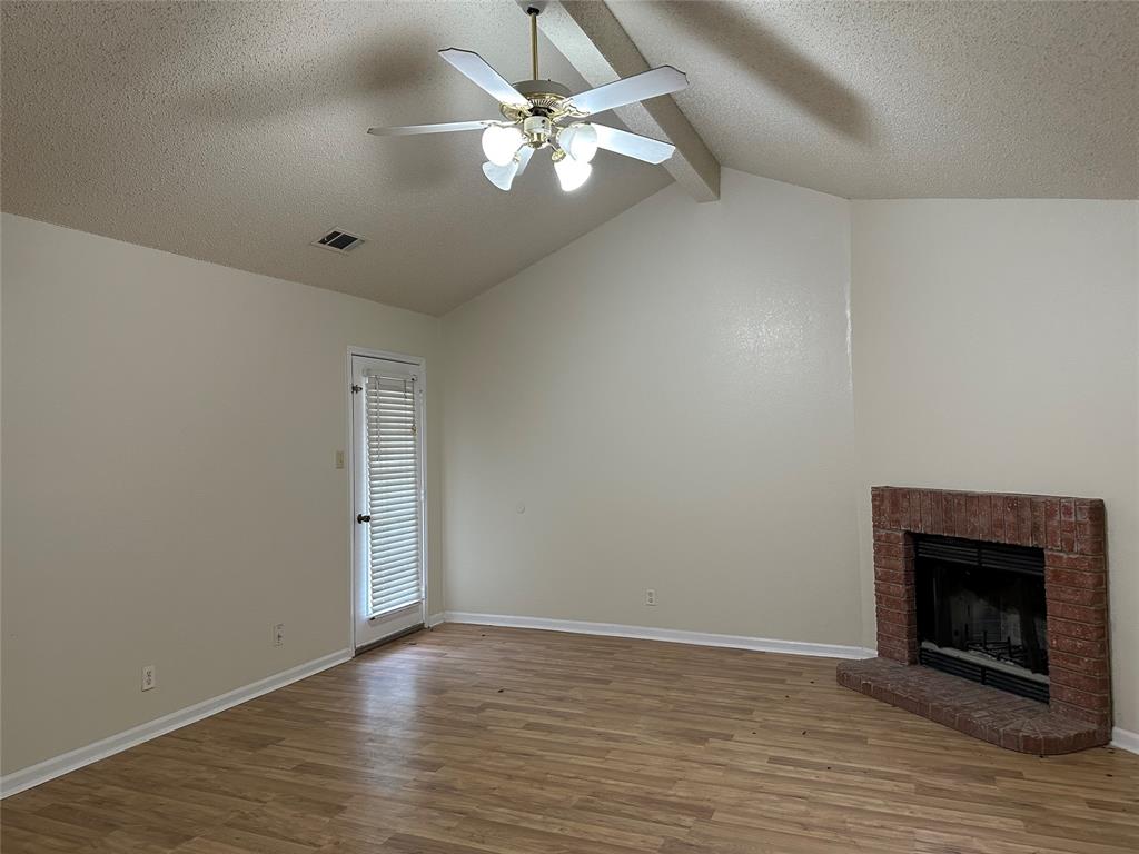 7629 Misty Ridge Drive North Fort Worth, TX 76137 - Photo 11 of 16 wooden floor in an empty room with a chandelier fan
