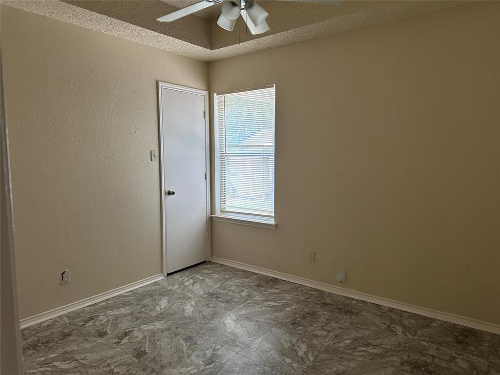7629 Misty Ridge Drive North Fort Worth, TX 76137 - Photo 13 of 16 an empty room with a window and a ceiling fan