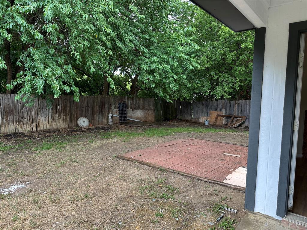 7629 Misty Ridge Drive North Fort Worth, TX 76137 - Photo 16 of 16 a view of a backyard with large trees and a barn