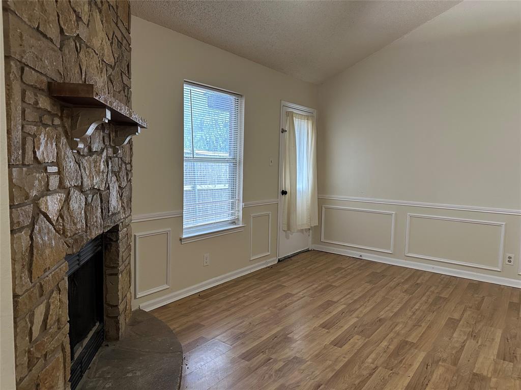 7629 Misty Ridge Drive North Fort Worth, TX 76137 - Photo 4 of 16 an empty room with windows and fireplace