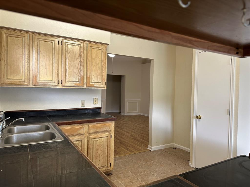7629 Misty Ridge Drive North Fort Worth, TX 76137 - Photo 7 of 16 a kitchen with a sink and cabinets
