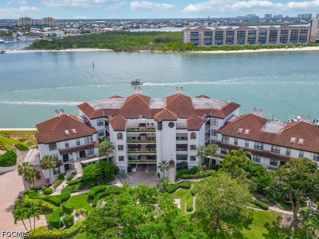 232 La Peninsula Boulevard, Unit 232 Naples, FL 34113 - Photo 27 of 44 an aerial view of a house with a lake view