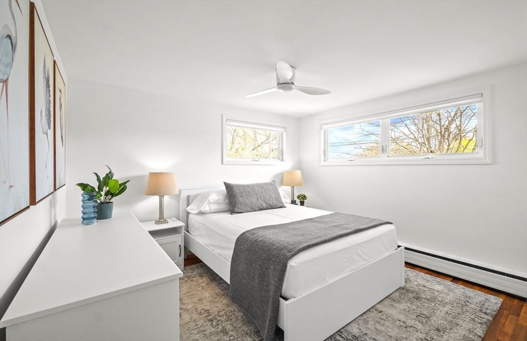 67 Montgomery Road Swansea, MA 02777 - Photo 14 of 41 a bedroom with a bed and a chandelier