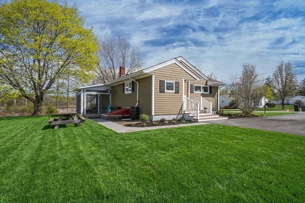 67 Montgomery Road Swansea, MA 02777 - Photo 29 of 41 a front view of a house with a garden and patio