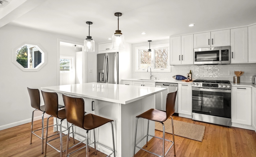 67 Montgomery Road Swansea, MA 02777 - Photo 6 of 41 a kitchen with stainless steel appliances kitchen island a table and chairs in it