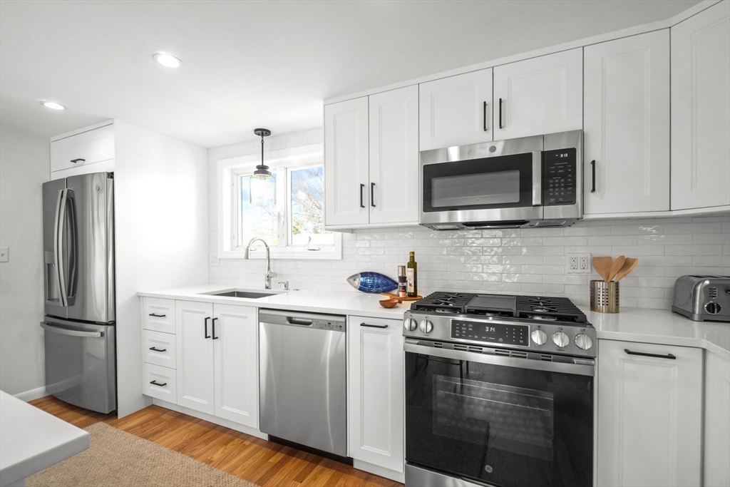 67 Montgomery Road Swansea, MA 02777 - Photo 7 of 41 a kitchen with cabinets stainless steel appliances and wooden cabinets