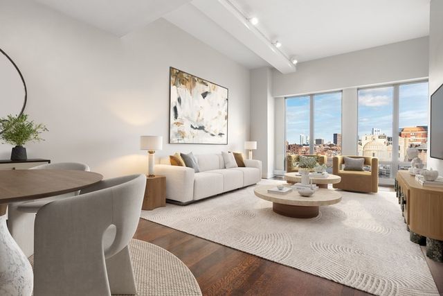 a living room with furniture and a potted plant
