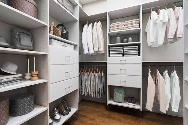 a view of walk in closet with clothes and shoes