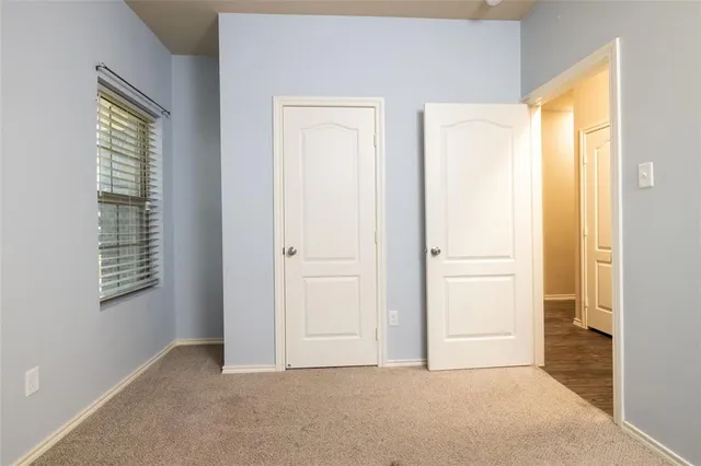 a view of an empty room with windows