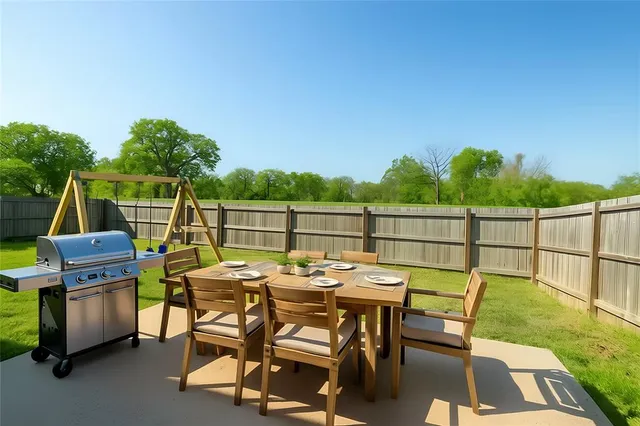 a view of a backyard with a fence