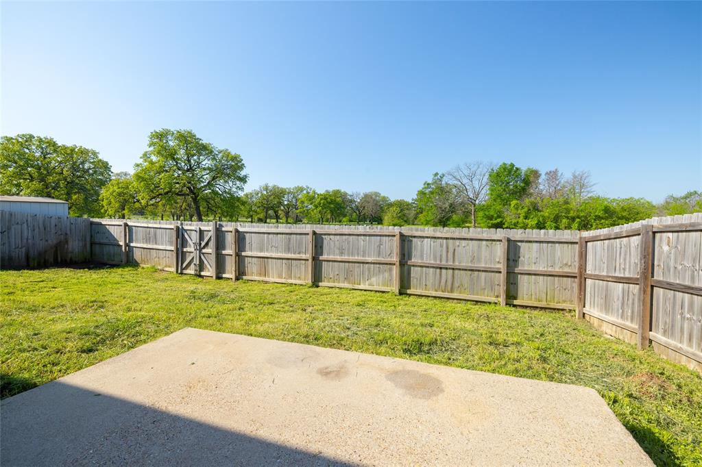 121 Mitchell Circle Terrell, TX 75160 - Photo 24 of 26 a view of a backyard with a fence