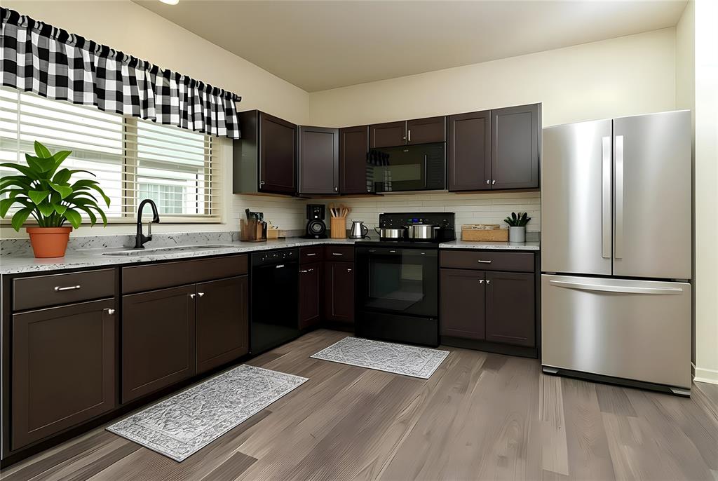 121 Mitchell Circle Terrell, TX 75160 - Photo 5 of 26 a kitchen with a sink a stove a refrigerator and cabinets
