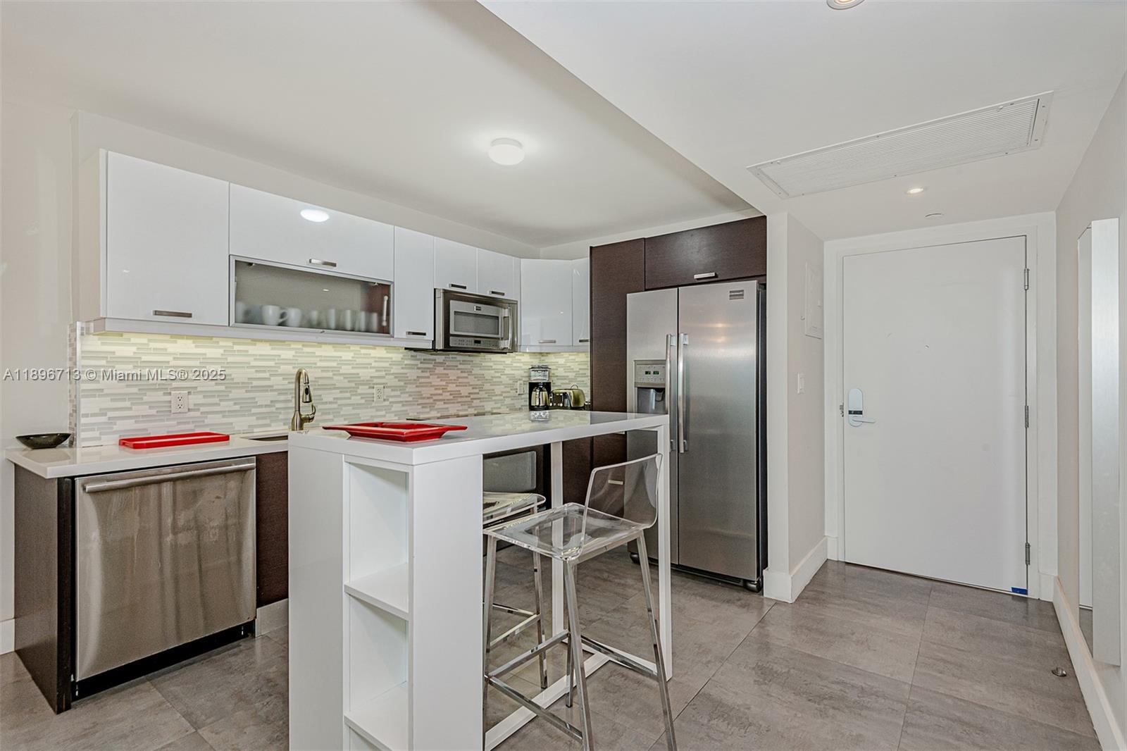 2301 Collins Avenue, Unit 723 Miami Beach, FL 33139 - Photo 18 of 26 a kitchen with stainless steel appliances granite countertop a stove refrigerator sink and cabinets