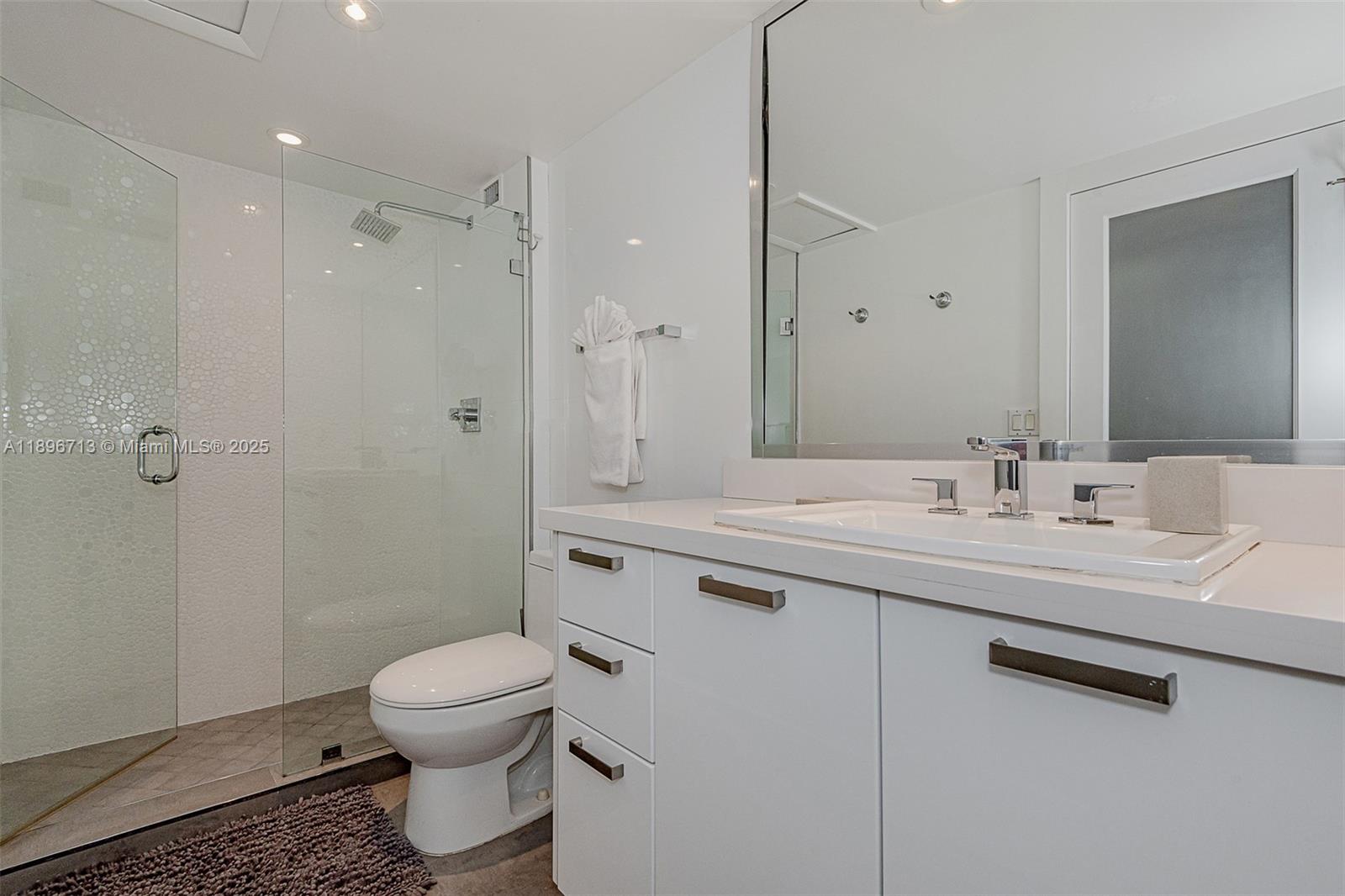 2301 Collins Avenue, Unit 723 Miami Beach, FL 33139 - Photo 22 of 26 a bathroom with a sink toilet and shower
