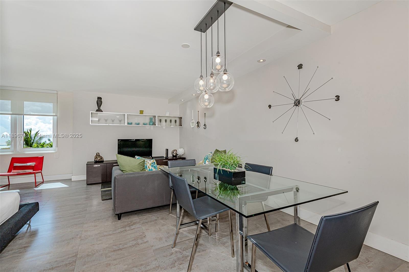 2301 Collins Avenue, Unit 723 Miami Beach, FL 33139 - Photo 3 of 26 a living room with furniture a fireplace and a chandelier