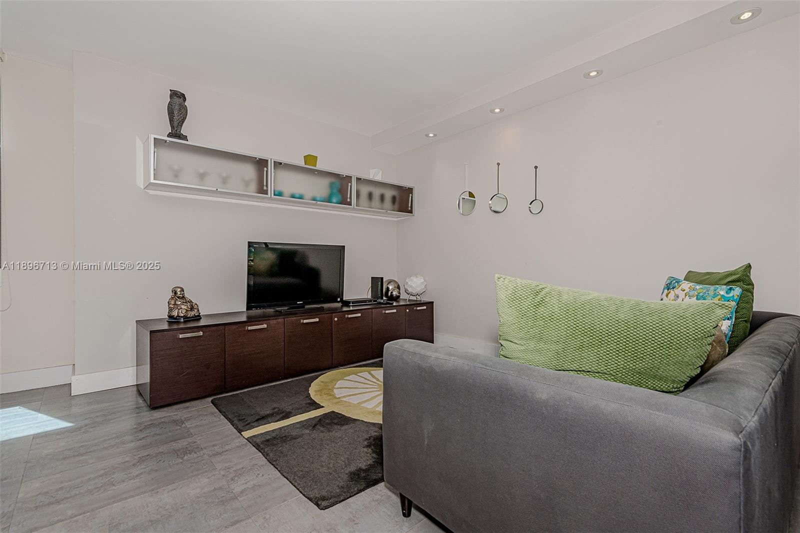 2301 Collins Avenue, Unit 723 Miami Beach, FL 33139 - Photo 6 of 26 a living room with furniture and a flat screen tv