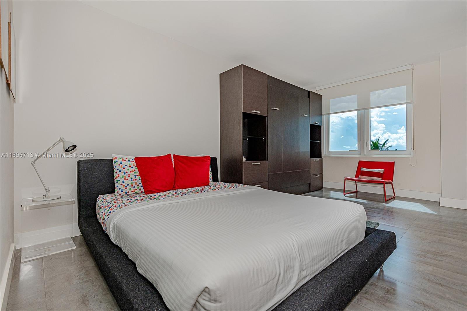 2301 Collins Avenue, Unit 723 Miami Beach, FL 33139 - Photo 7 of 26 a bedroom with a bed and wooden floor