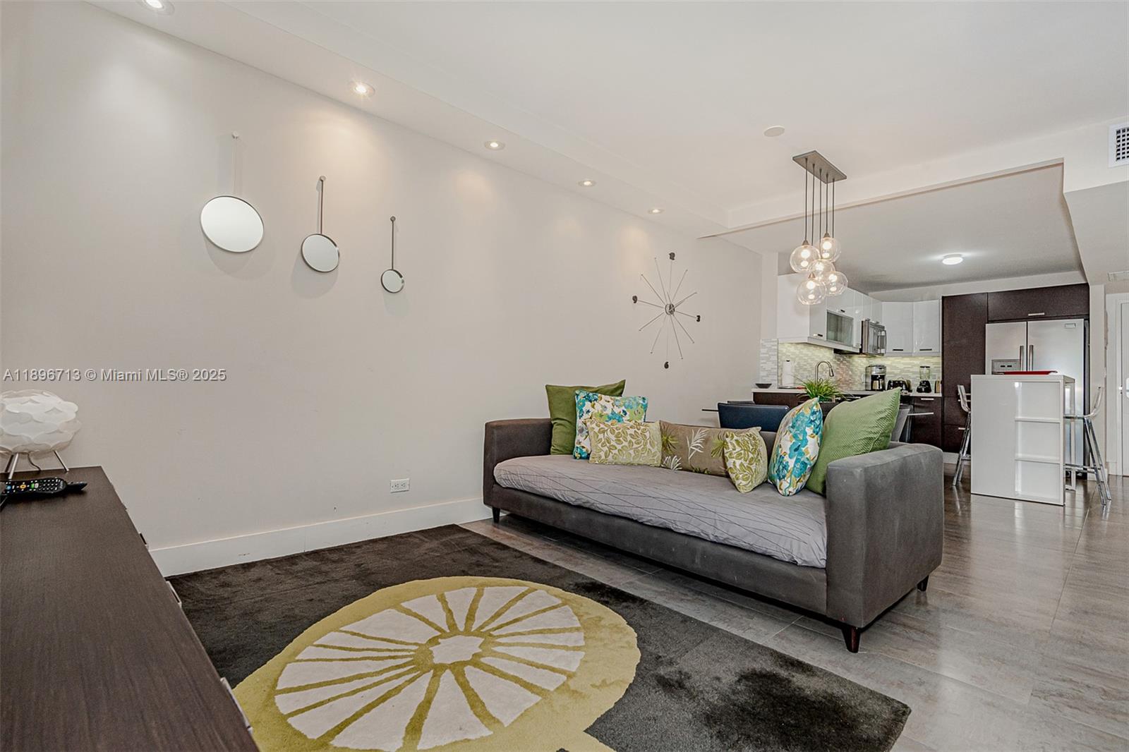 2301 Collins Avenue, Unit 723 Miami Beach, FL 33139 - Photo 10 of 26 a living room with furniture and a wooden floor