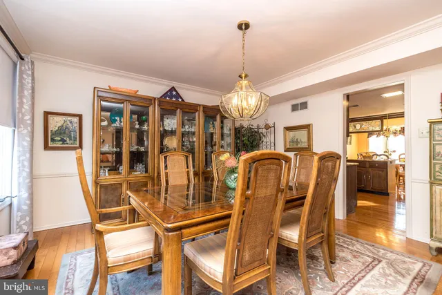 a view of empty room with window and chandelier