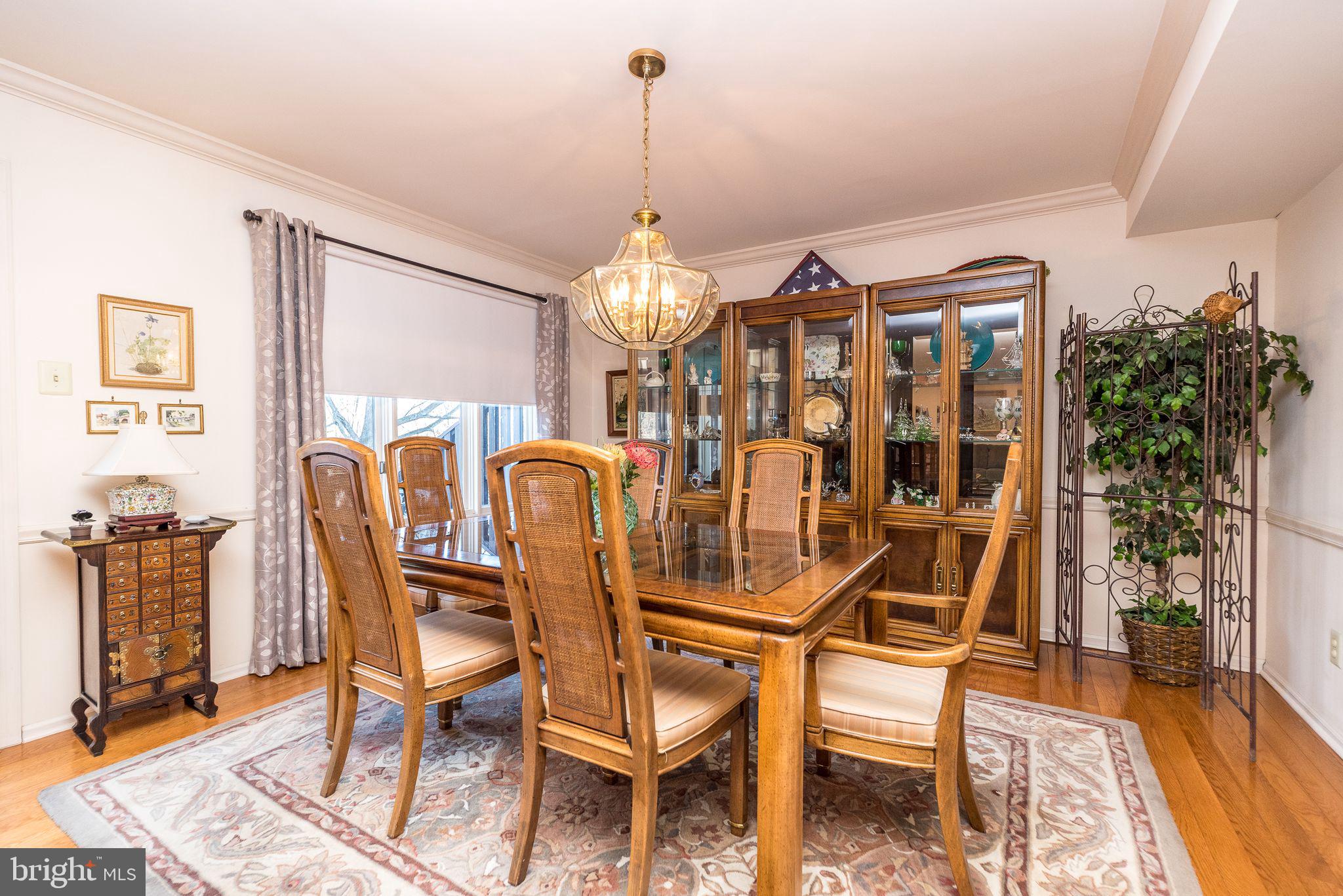 68 Amity Drive Chesterbrook, PA 19087 - Photo 16 of 62 a dining room with furniture a chandelier and wooden floor