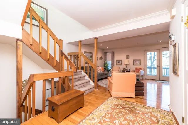 a bedroom with a bed a mirror on dresser and a window