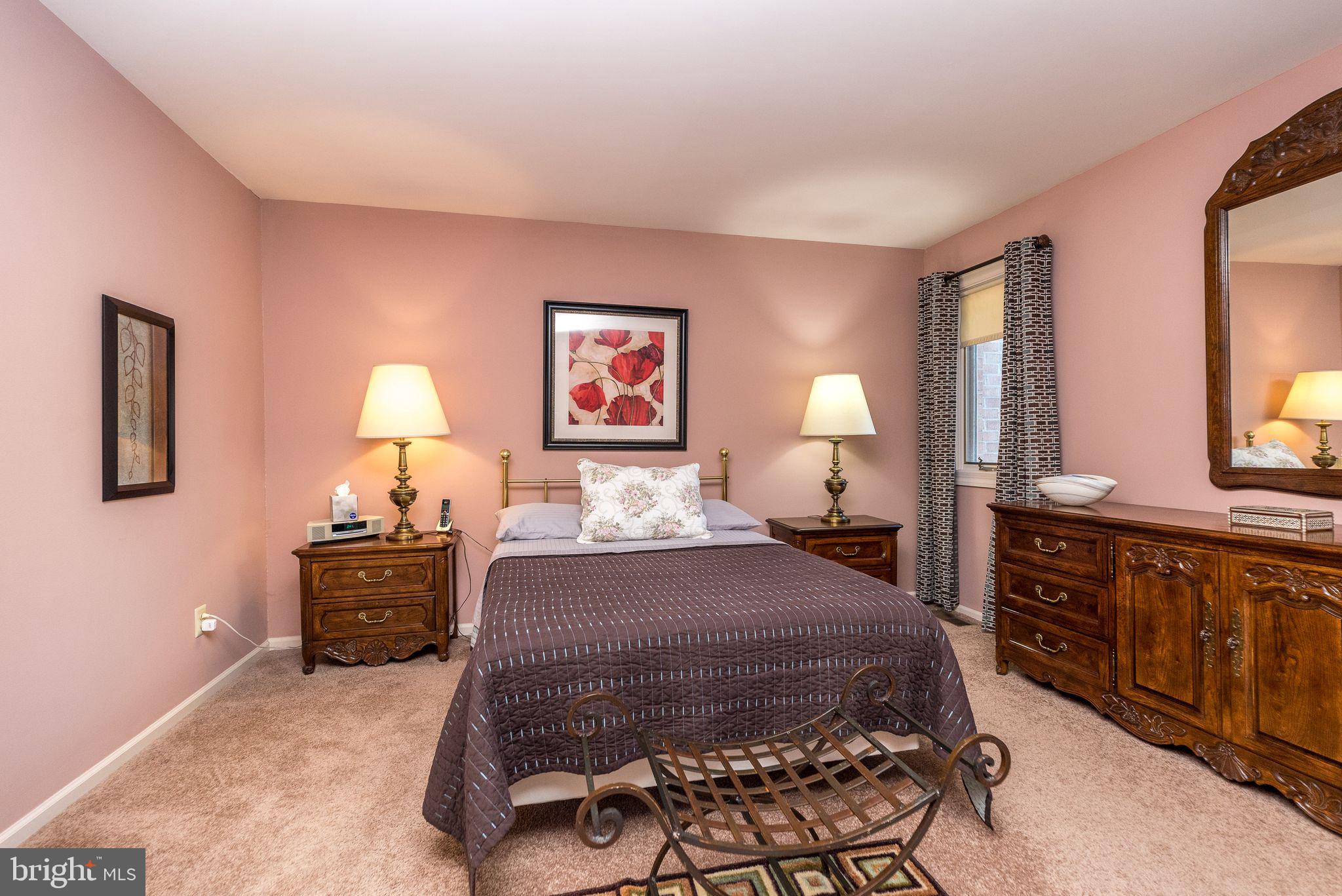 68 Amity Drive Chesterbrook, PA 19087 - Photo 26 of 62 a bedroom with a bed and a chandelier