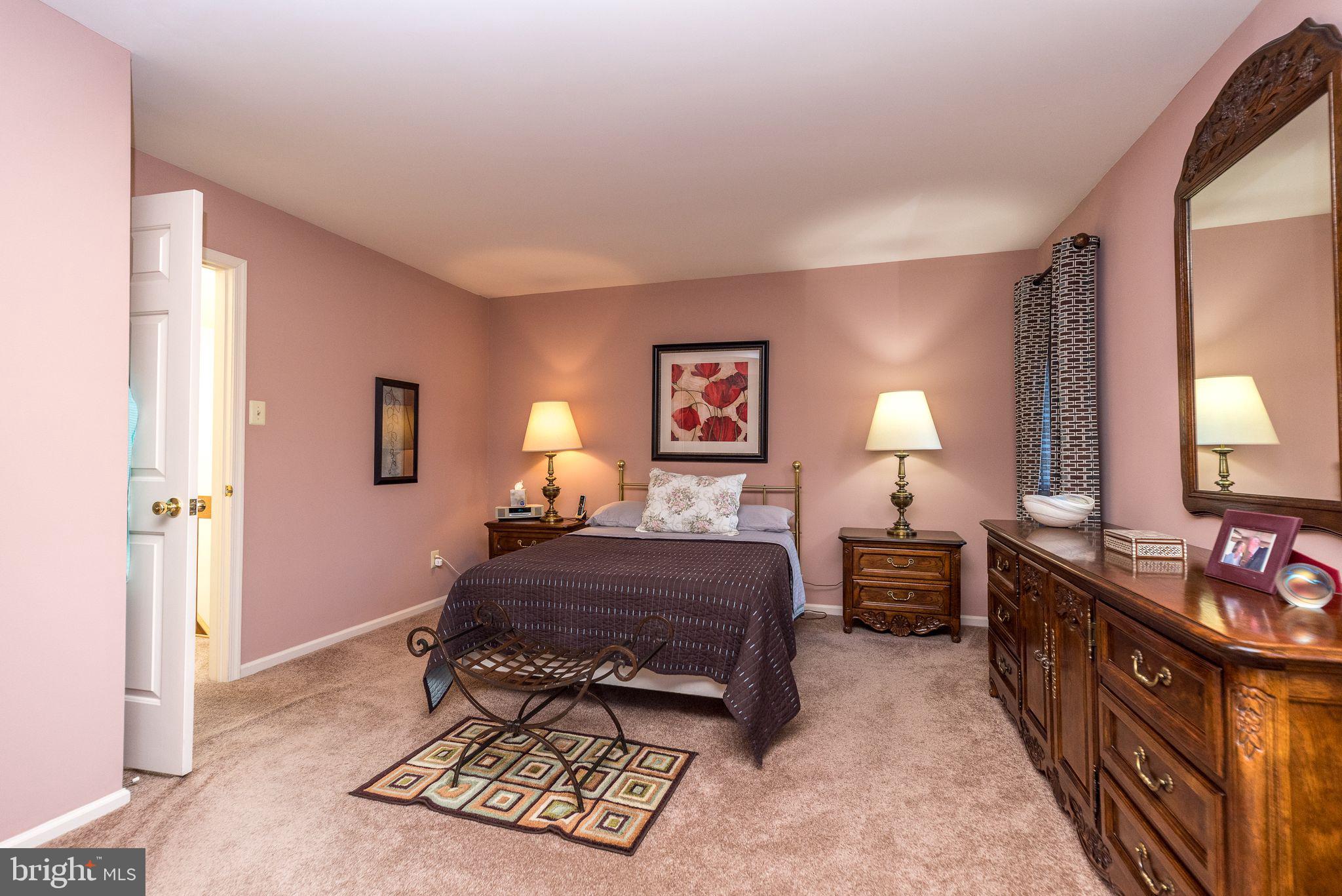 68 Amity Drive Chesterbrook, PA 19087 - Photo 28 of 62 a bedroom with a bed a mirror on dresser and a window
