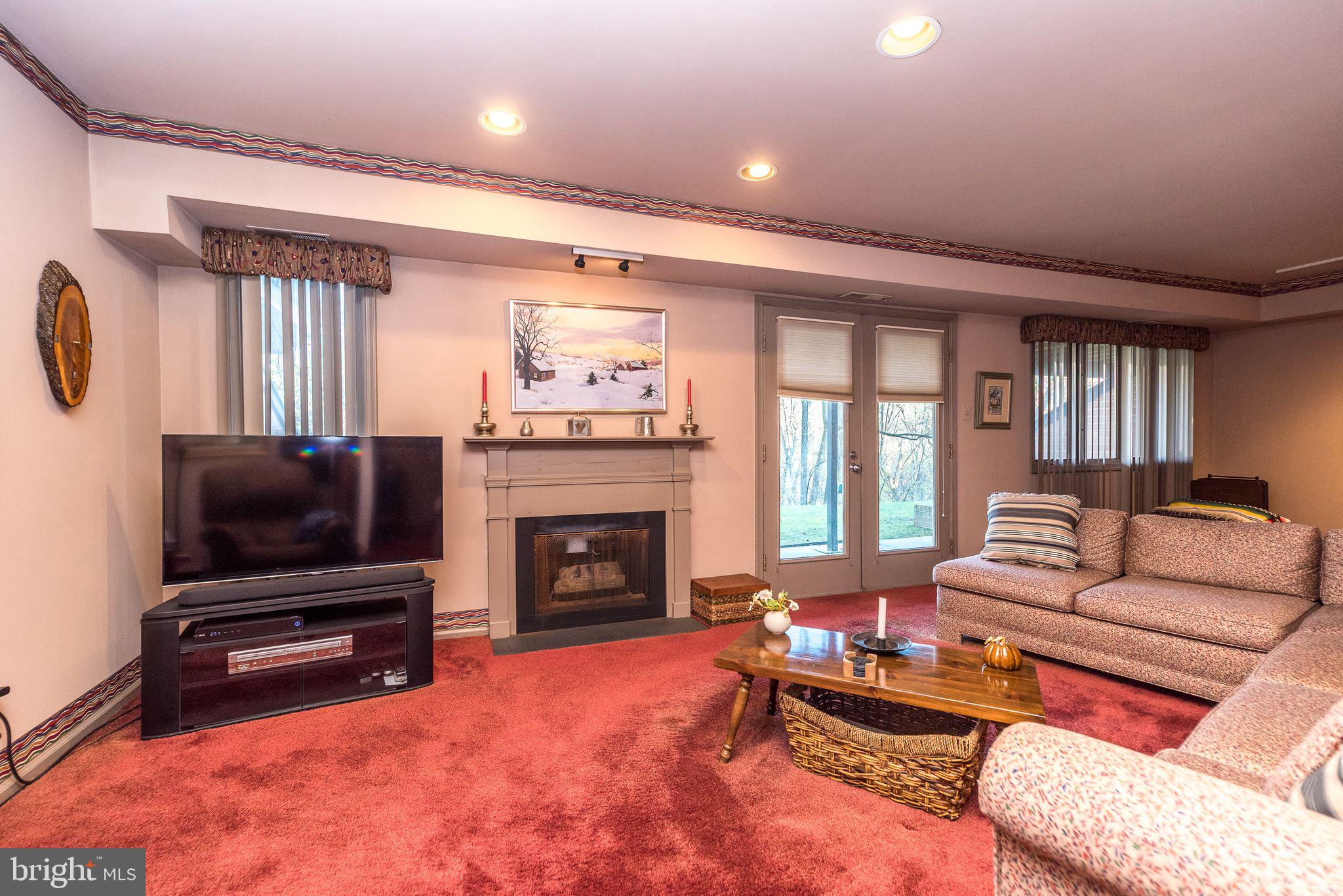68 Amity Drive Chesterbrook, PA 19087 - Photo 43 of 62 a living room with furniture a flat screen tv and a fireplace
