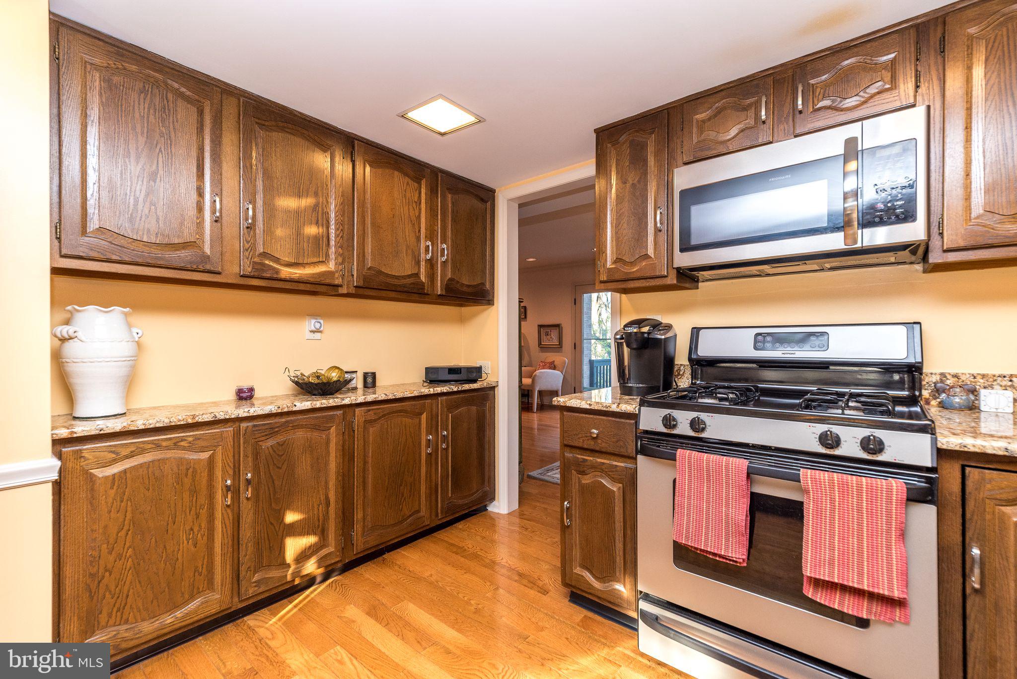 68 Amity Drive Chesterbrook, PA 19087 - Photo 7 of 62 a kitchen with wooden cabinets and a stove top oven