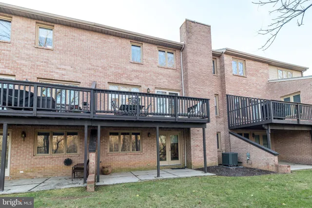 a view of a dining room with furniture and a chandelier