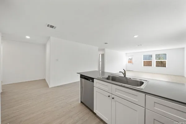 a kitchen with a sink and cabinets