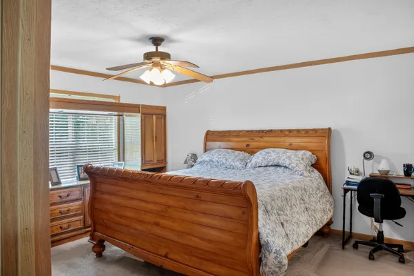 a bedroom with a bed and a chandelier
