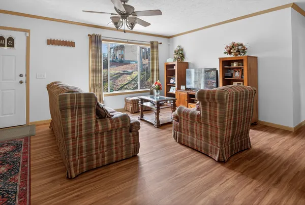 a living room with furniture and wooden floor