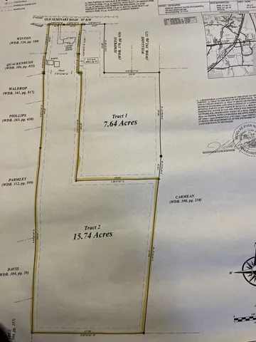 a view of an empty room with a window and a kitchen