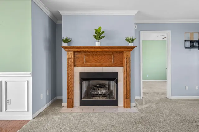 a view of an empty room with a chandelier fan