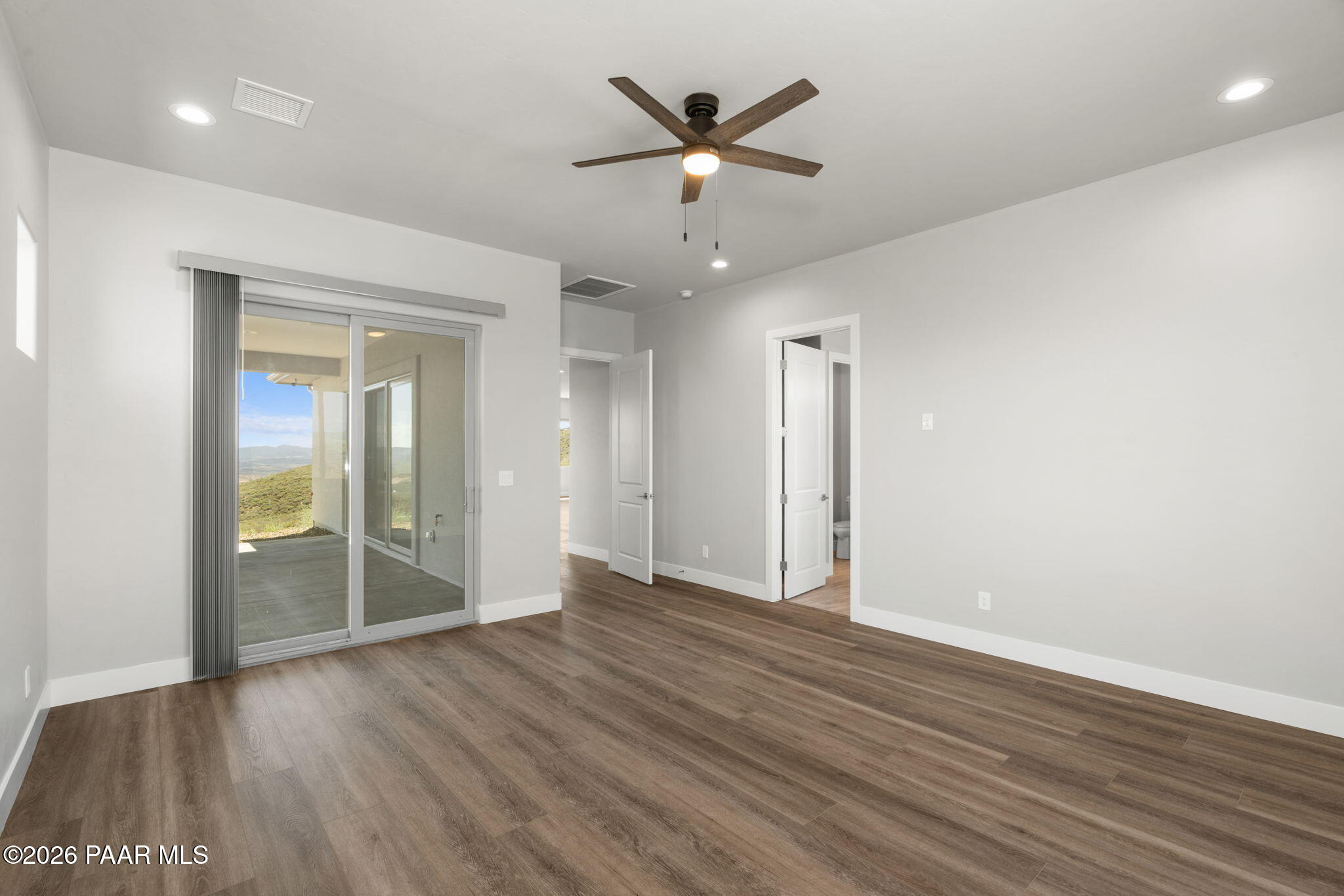 15690 East Orchard View Road Dewey, AZ 86327 - Photo 23 of 26 an empty room with wooden floor and door