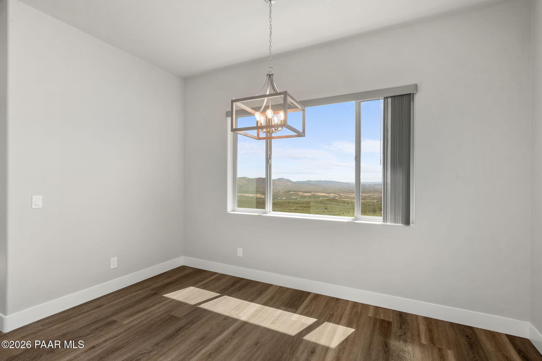 15690 East Orchard View Road Dewey, AZ 86327 - Photo 24 of 26 a view of a room with wooden floor windows and a chandelier